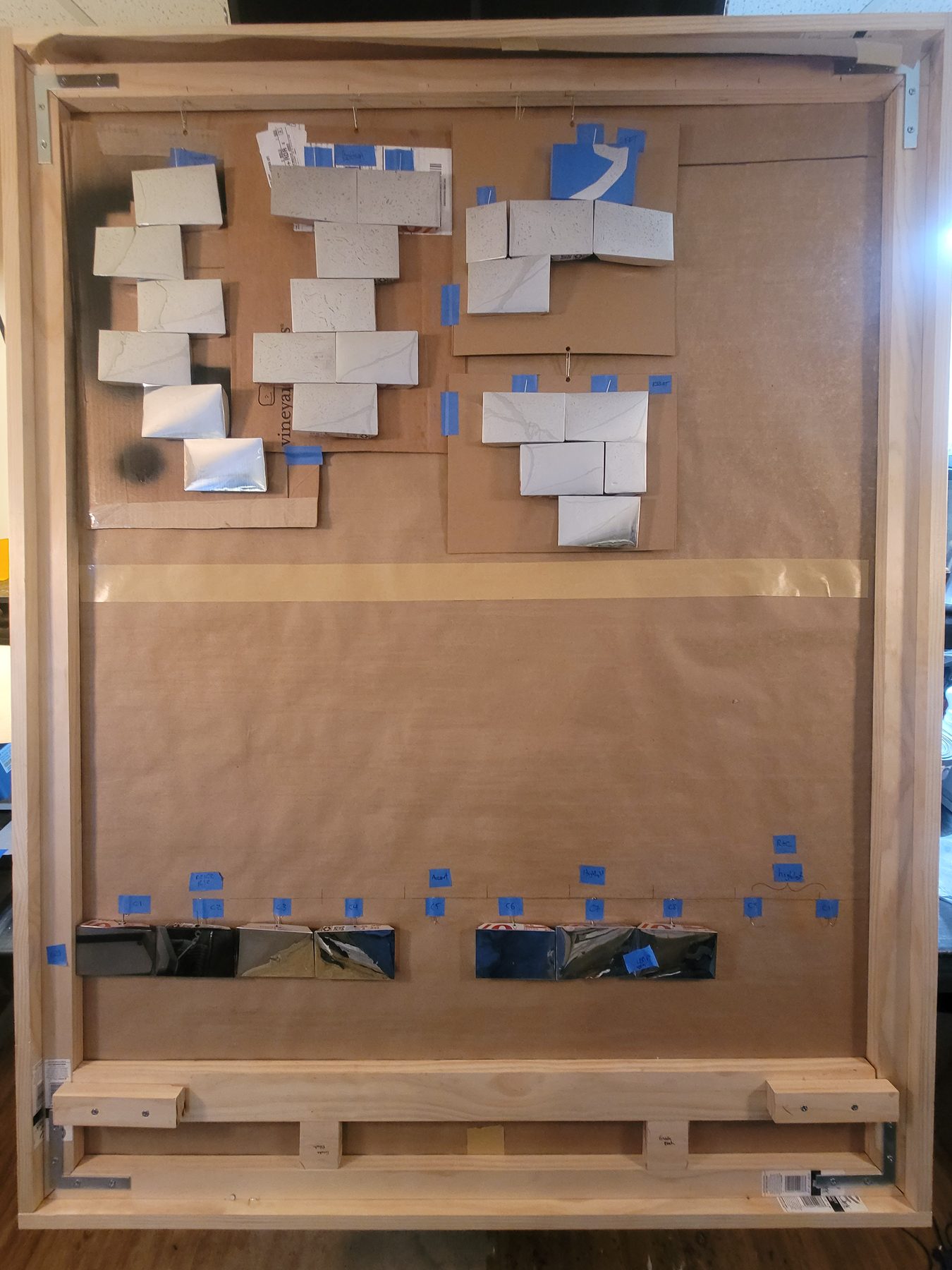 Mosaic assembly board with many aluminum tiles placed in progress