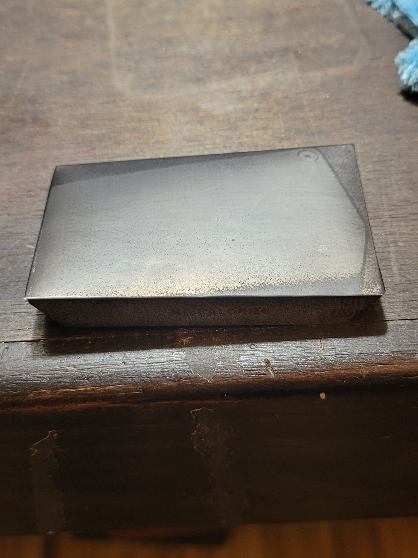 Finished small aluminum blank tile on a tabletop