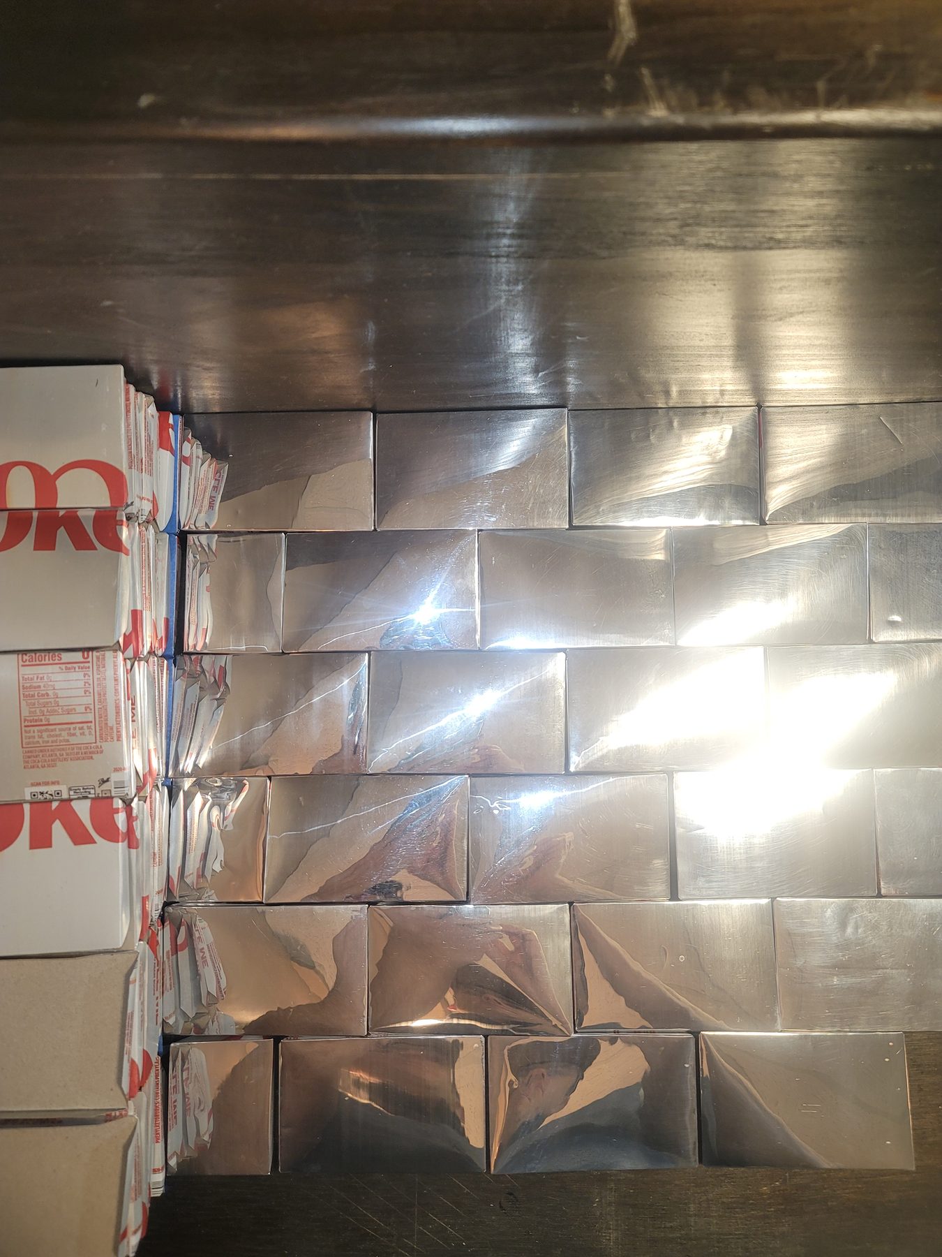 Reflective aluminum mosaic tiles laid out as a light field