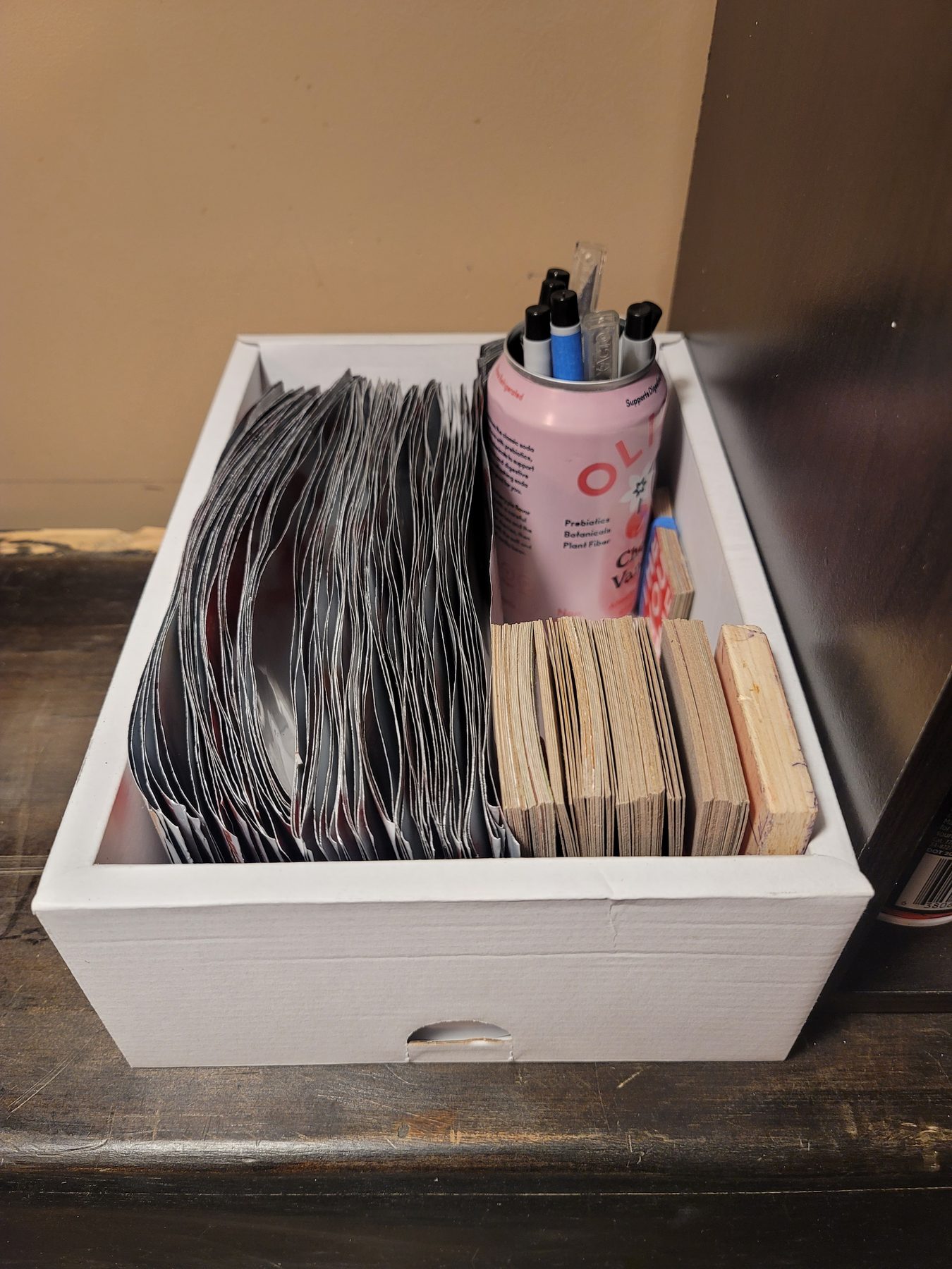 Box of prepared aluminum mosaic pieces sorted for assembly